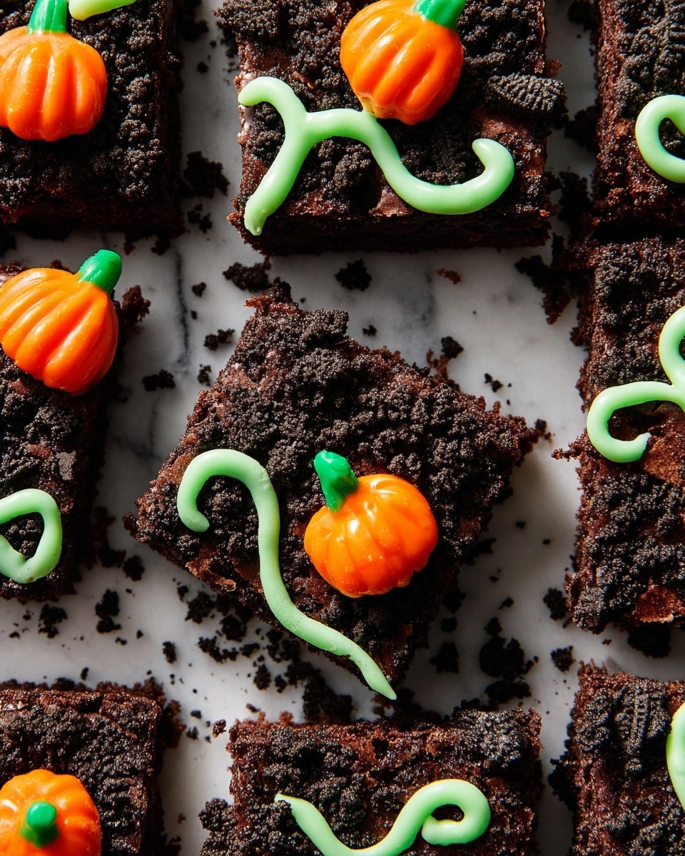 The image shows several square brownies placed closely on a white marbled surface, each covered with a rough-textured, dark chocolate crumb layer on top. Each brownie has a small, bright orange pumpkin-shaped candy with a green stem placed near the center, adding a pop of color. Thin, bright green icing lines are drawn randomly across the top of the brownies, creating curly and wavy patterns that look like vines. The brownies' edges are straight, and some crumbs are scattered around them. The photo taken with an iphone --ar 4:5 --v 7