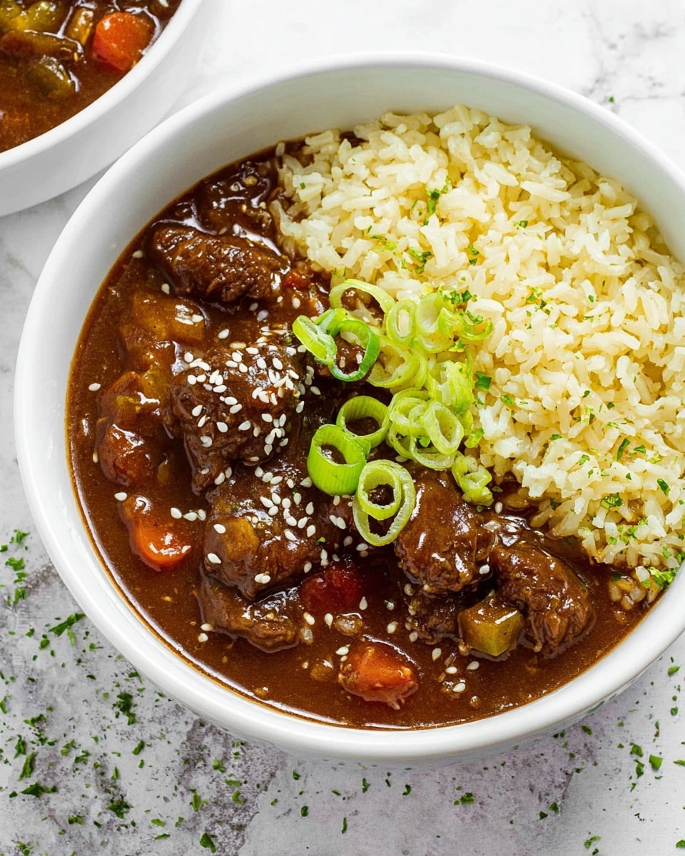 A white bowl filled halfway with a dark brown stew containing tender-looking chunks of meat and small pieces of vegetables, topped with white sesame seeds scattered on the stew surface. The other half of the bowl is filled with light yellow rice, slightly fluffy with visible grains. On top of the rice, there are a few bright green sliced scallions adding color contrast. The bowl is placed on a white marbled surface with some green herb bits around. Photo taken with an iphone --ar 4:5 --v 7