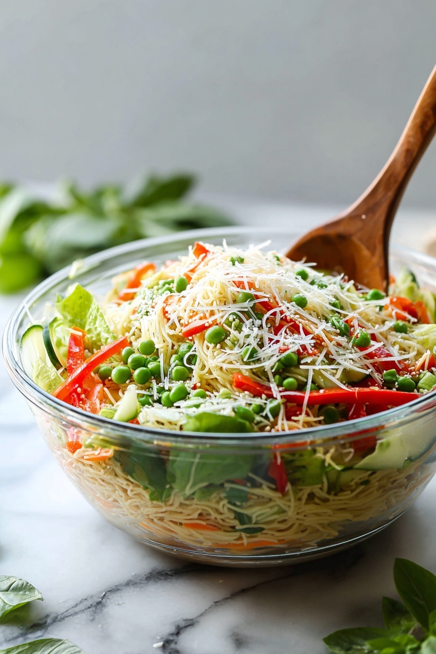 Spring Roll Salad with Spicy Ginger Dressing, Vietnamese spring roll salad, healthy spring salad recipes, easy summer salads, crunchy veggie salad - A clear glass bowl filled with a colorful layered salad sits on a white marbled surface, with a wooden spoon inside. The bottom layer consists of mixed green leafy vegetables, topped by thin noodles with some shredded carrot mixed in. On top of the noodles, sliced red bell pepper strips, green peas, and cucumber slices are scattered. The salad is finished with a sprinkle of grated cheese and chopped nuts or seeds, adding texture and color contrast. Some green herbs are mixed throughout. In the background, there is some green foliage slightly blurred, and a white cloth is partially visible next to the bowl. Photo taken with an iphone --ar 2:3 --v 7