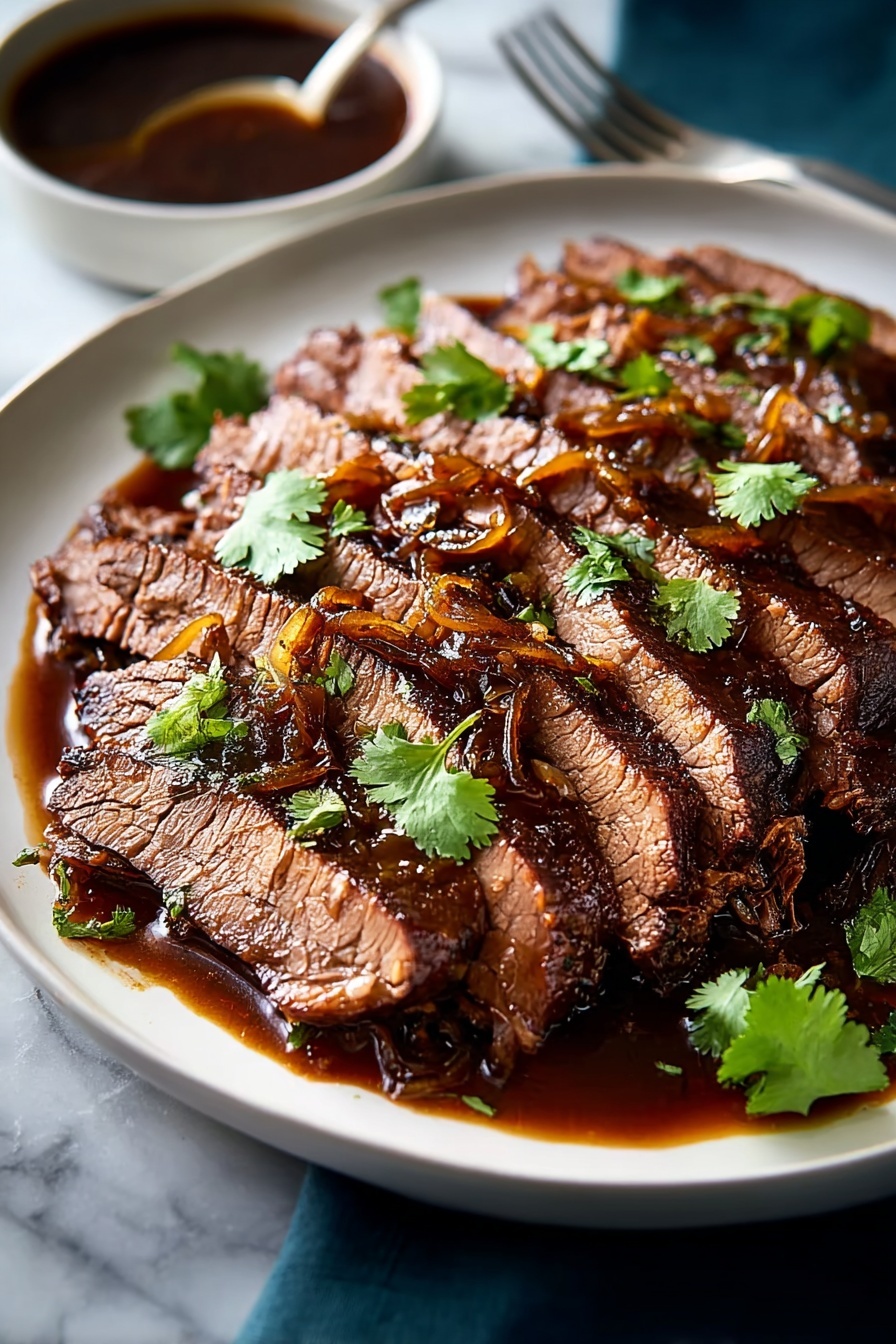 Sweet & Savory Caramelized Pulled Beef Brisket, caramelized pulled beef, tender brisket recipes, flavorful beef dishes, slow cooker beef recipes - The dish shows a large round white plate filled with many layers of thin, brown, cooked meat slices arranged side by side, creating a textured, fibrous look. On top of the meat, there is a thick layer of glossy, golden-brown caramelized onions spread evenly. Scattered fresh green parsley leaves add a splash of color on top. At the back right edge of the plate, two lemon wedges with bright yellow skin rest, adding a fresh contrast. The plate sits on a white marbled surface. photo taken with an iphone --ar 2:3 --v 7