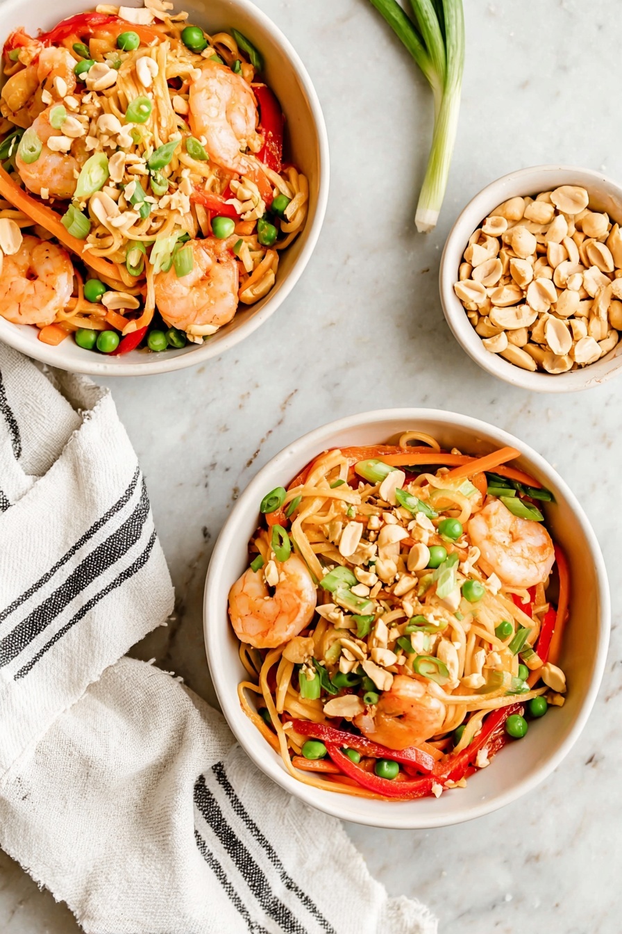 Thai Peanut Sauce Noodles with Shrimp, spicy peanut noodle dish, quick Thai shrimp noodles, healthy Asian noodle recipe, savory shrimp noodle bowl - Two white bowls sit on a white marbled surface filled with a colorful shrimp noodle dish. Each bowl has three main layers: at the bottom, light beige noodles with a soft texture; in the middle, bright orange carrot strips and green peas mixed with red bell pepper slices; on top, pinkish shrimp, chopped light brown peanuts, and fresh green onion pieces scattered over all. Some peanuts are also spread loosely on the surface nearby, and a white cloth with thin black stripes is placed next to the front bowl. photo taken with an iphone --ar 2:3 --v 7
