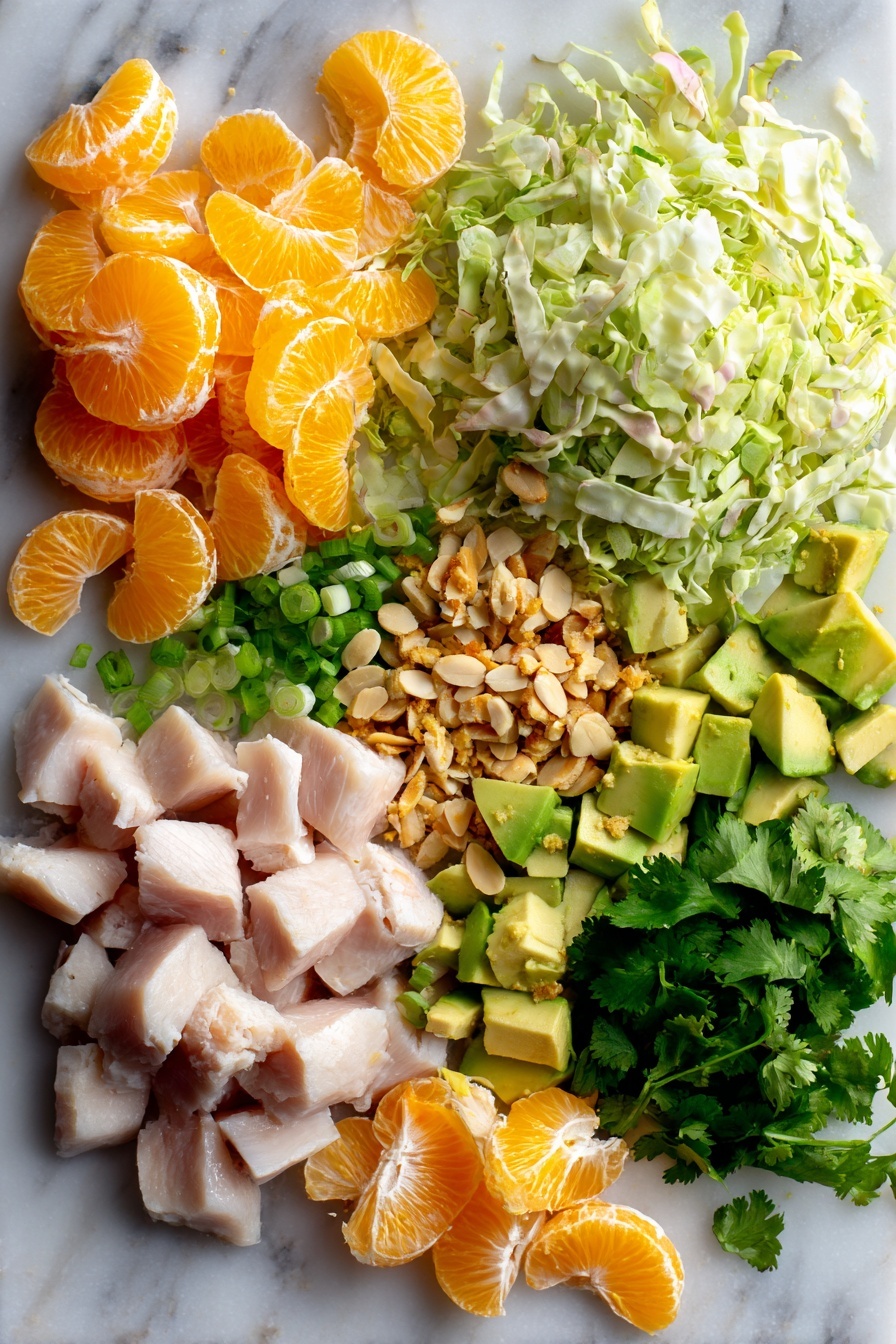 Orange Sesame Chicken Salad, healthy chicken salad with oranges, citrus chicken salad, quick chicken salad recipe, flavorful fruit and chicken salad - Flat lay of cubed raw chicken breast, thinly shredded green cabbage, bright orange segments, diced creamy avocado, thinly sliced green onions, fresh chopped cilantro, toasted slivered almonds, and golden toasted sesame seeds arranged beautifully with a zest of orange and fresh ginger root pieces, placed on a white marble surface, photo taken with an iphone --ar 2:3 --v 7