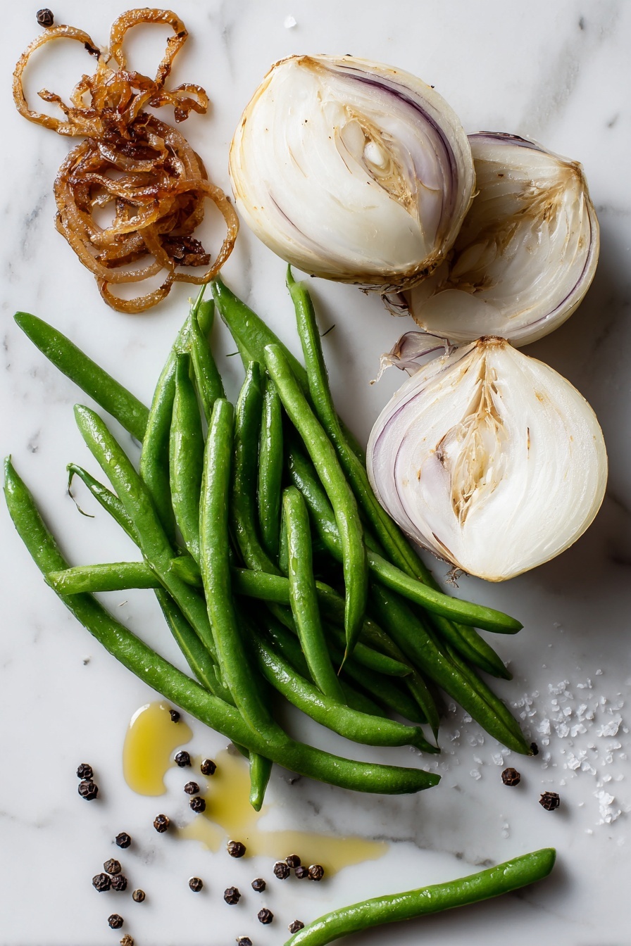 Roasted Green Beans with Caramelized Onions, green bean side dish, caramelized onion green beans, healthy roasted green beans, easy green bean recipes - Flat lay of fresh bright green beans, two large sliced Vidalia onions showing their creamy white and purple layers, a small pile of golden caramelized onions glistening with rich color, a drizzle of extra virgin olive oil shimmering on the marble, and scattered kosher salt crystals and black peppercorns, all beautifully arranged with natural light highlighting their textures, placed on a white marble surface, photo taken with an iphone --ar 2:3 --v 7